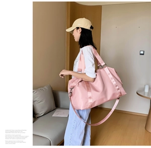 Pink large gym bag shown on shoulder, highlighting spacious capacity and nylon texture