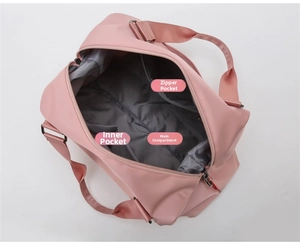 Detailed interior of pink waterproof gym bag showing main pocket and zipper compartment