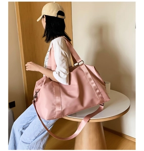 Pink waterproof fitness bag showing large capacity and adjustable shoulder strap style