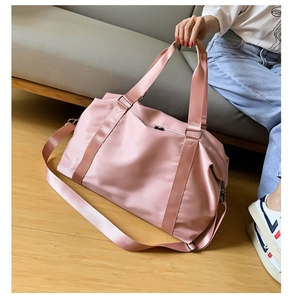 Close-up of pink waterproof gym bag with reinforced handles and adjustable shoulder strap