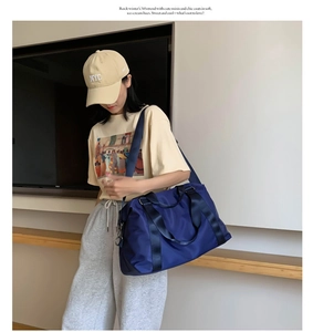 Detail of blue fitness bag with sturdy handles and adjustable shoulder strap for travel
