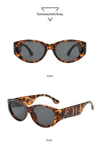 Close-up detail of vintage oval sunglasses featuring tortie frames and gray lenses