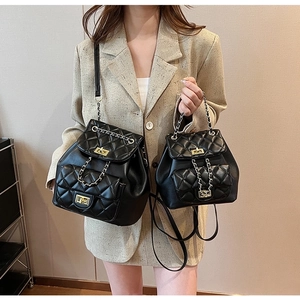Quilted black chain backpack with gold rotary clasp and dual sizes for daily commute
