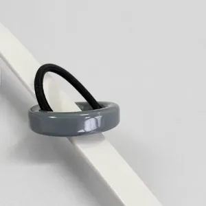 Detail of gray minimalist acetate geometric buckle hair tie with black elastic band
