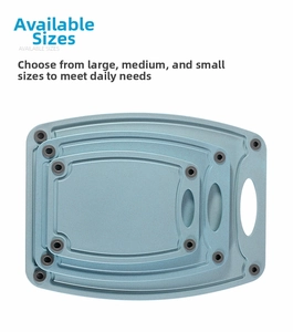 Three-piece light blue wheat straw cutting board set with non-slip pads and hanging handles