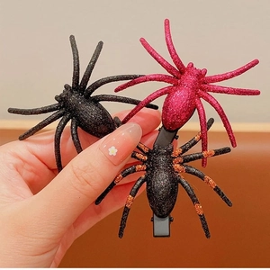 Glittery spider hair clips for Halloween in black, red, and orange for girls' party outfits
