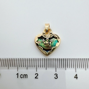 Macro shot of 18K gold-plated heart pendant with abalone shell and crown detail