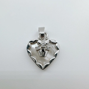 Detailed close-up of 18K gold heart pendant with natural mother of pearl shell and crown