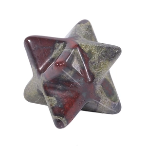 Macro shot of green and red speckled natural stone Merkaba star with polished finish