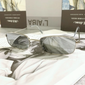 Close-up of retro rectangular silver metal sunglasses placed on a fashion magazine