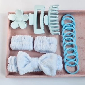 Close-up of light blue hair accessory set featuring velvet bow headband and matte hair clips