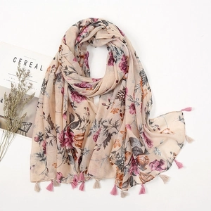 Detailed view of bohemian floral print scarf with soft pink fringe tassels on edges