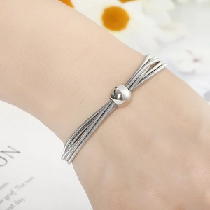 Fashionable elastic stainless steel spring bracelet with metallic ball charm for men and women