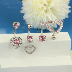 Pink heart-shaped zircon belly rings set in silver stainless steel on display stand
