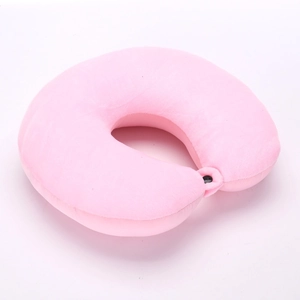 Pink short plush U-shaped travel neck pillow with secure black snap button closure