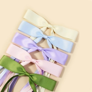 Set of five colorful satin ribbon bow hair clips in pastel beige, blue, purple, and pink