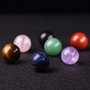 Close-up of seven polished natural crystal spheres showing vibrant colors and textures