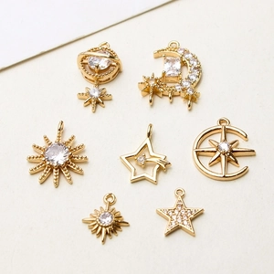 Detailed macro view of gold-plated celestial charms with micro-pave cubic zirconia