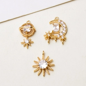 Gold celestial pendants with sun moon and saturn charms inlaid with zircons