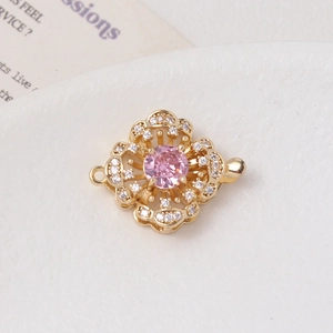 Detail of 14K gold plated flower clasp with pink zircon and double connection loops