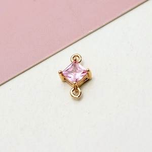 Detailed view of pink zircon rhicombus charm with dual loops for DIY jewelry making