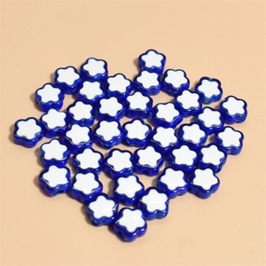 Macro shot of 10mm blue and white flower-shaped beads for DIY jewelry making and crafts