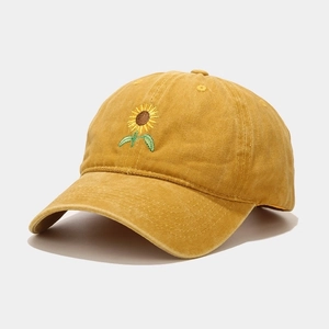 Detail of sunflower embroidery on yellow washed cotton vintage baseball cap
