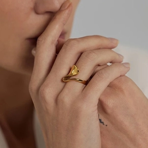 Close-up of a 18K gold plated stainless steel irregular ring on a model finger
