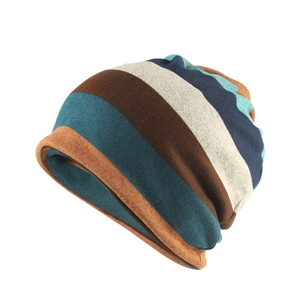Detail of colorful striped velvet beanie showing warm textures and soft knitted fabric