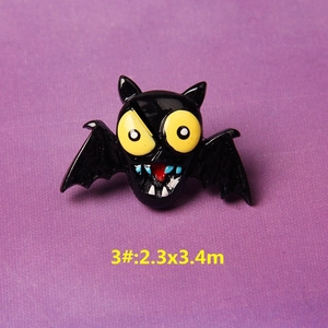 Detail of cartoon Halloween bat brooch with yellow eyes and vibrant enamel finish