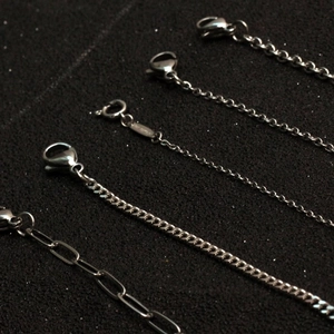 Assorted silver stainless steel chains featuring curb, cable, and paperclip styles