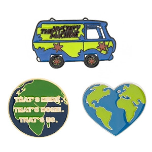 Detailed view of enamel pins featuring Mystery Machine van, globe, and heart map