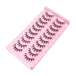 10 pairs of natural criss-cross false eyelashes on a pink tray with a white background
