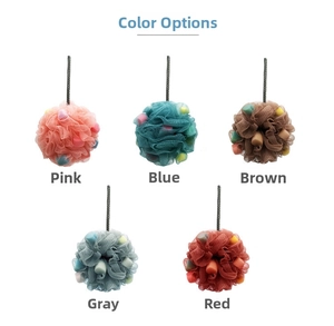 Detail of colorful shower loofahs with sponge cubes inside and a hanging rope design