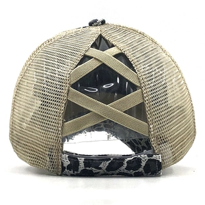 Close-up of ponytail criss-cross elastic bands on leopard print mesh trucker hat