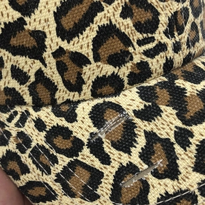 Macro detail of leopard print baseball cap with distressed edge and white stitching