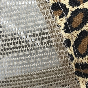 Close-up of breathable mesh fabric and leopard print pattern on a vintage baseball cap