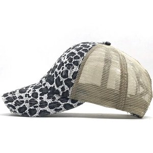 Detail of leopard print fabric and breathable mesh panels on a stylish baseball cap