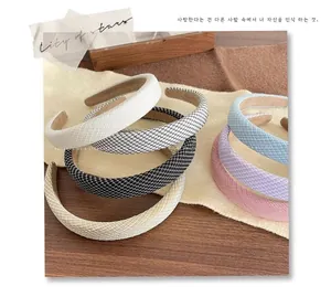 Macro shot of assorted thick padded sponge headbands in solid colors and checkered patterns