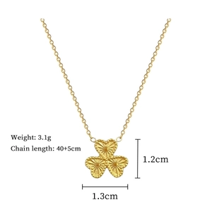 Detailed view of golden clover pendant with dimensions 1.3cm x 1.2cm and 3.1g weight
