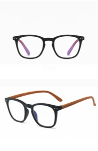 Detail of matte black reading glasses with wood grain temples and blue light filter