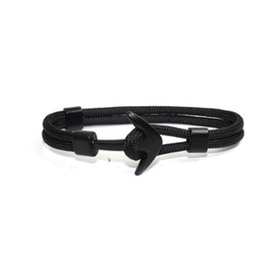 Close-up of black nautical rope bracelet featuring a polished metal anchor clasp buckle