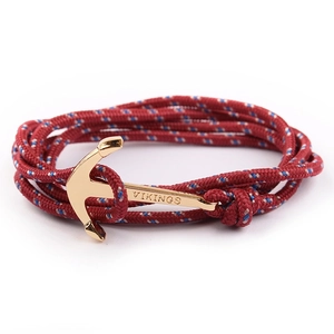 Macro shot of gold anchor clasp with Vikings engraving and tricolor nylon rope cord