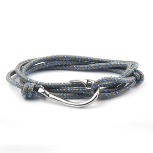 Detail of woven nautical rope bracelet with silver fish hook clasp in grey and blue