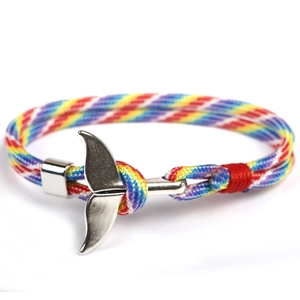 Close-up of rainbow braided paracord bracelet with a silver whale tail metal buckle clasp