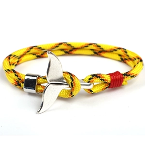 Detail of yellow paracord braided bracelet with silver whale tail metal buckle