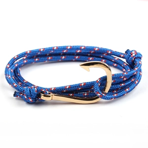 Close-up of blue braided nautical rope bracelet with a polished golden fish hook clasp