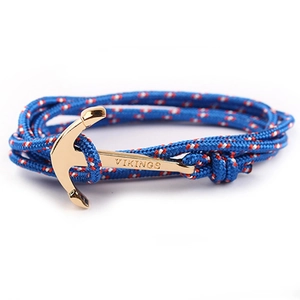 Detail of blue red white nylon rope bracelet with gold anchor clasp engraved with VIKINGS