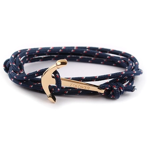 Close-up of blue nylon cord bracelet featuring a gold-plated Viking anchor clasp