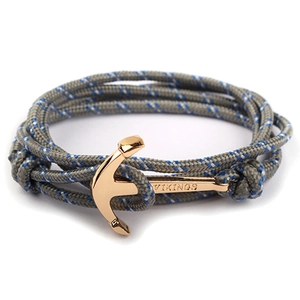 Close-up of blue and grey nylon rope bracelet with golden VIKINGS anchor clasp